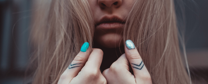 Girl with detailed tattoos on her thumbs. Tattoo prices in the UK vary on several aspects.