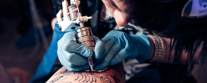 A tattoo machine being used by a professional tattoo artist