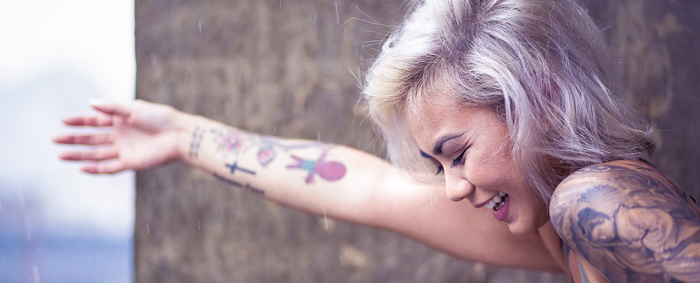 Cute tattooed girl looking happy
