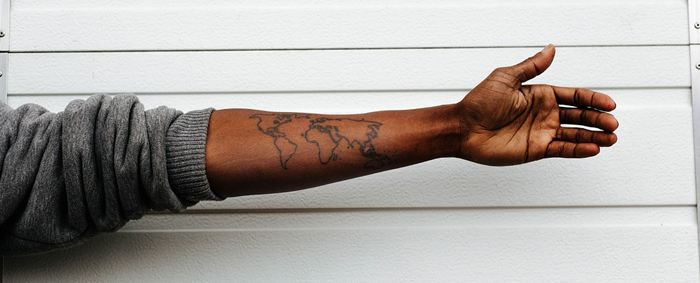 A map of the world tattooed to the inside of a forearm
