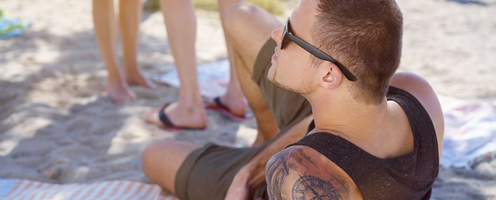 Sunbathing with tattoos